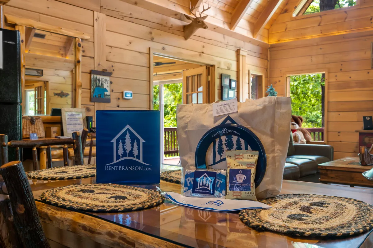 This image focuses on a wooden dining table adorned with decorative placemats and surrounded by large windows that offer glimpses of nature. The setting is designed for family meals, game nights, or relaxing together, with a cozy and inviting ambiance.